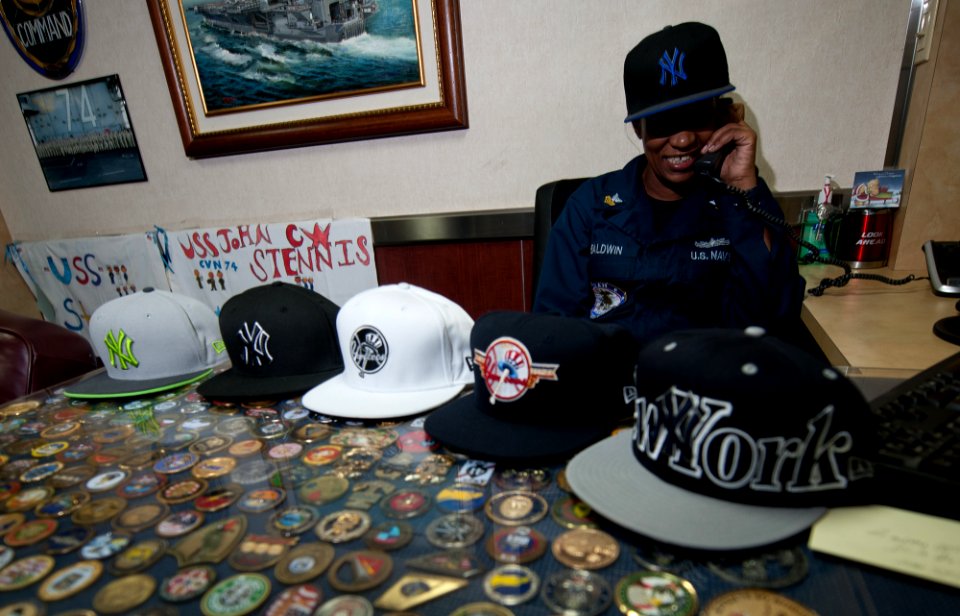 US Navy 111214-N-OY799-346 Legalman 1st Class Lakisha Baldwin takes a holiday telephone call from N.Y. Yankees Manager Joe Girardi