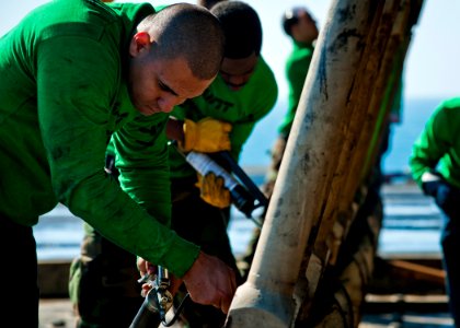 US Navy 111213-N-BT887-109 Sailors perform maintenance on a jet blast deflector aboard the Nimitz-class aircraft carrier USS John C. Stennis (CVN 7