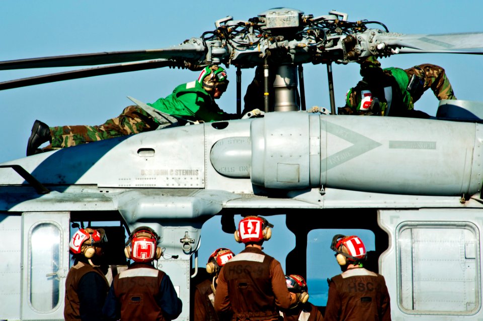 US Navy 111214-N-BT887-350 Sailors perform maintenance on a helicopter
