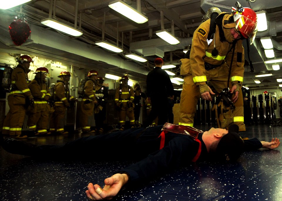 US Navy 111215-N-KA046-055 A Sailor discovers a mock casualty during a general quarters drill