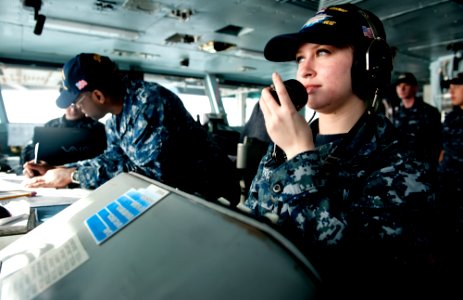 US Navy 111211-N-OY799-048 Operations Specialist Seaman Apprentice Michell Prom, from San Diego, receives reports from lookouts on the bridge aboar