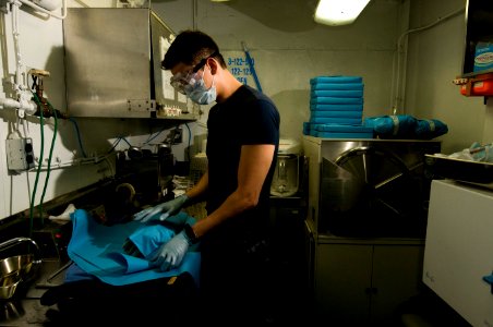 US Navy 111213-N-TZ605-158 Hospital Corpsman 2nd Class Thomas Sorano prepares dental tools for sterilization in the central sterilization room