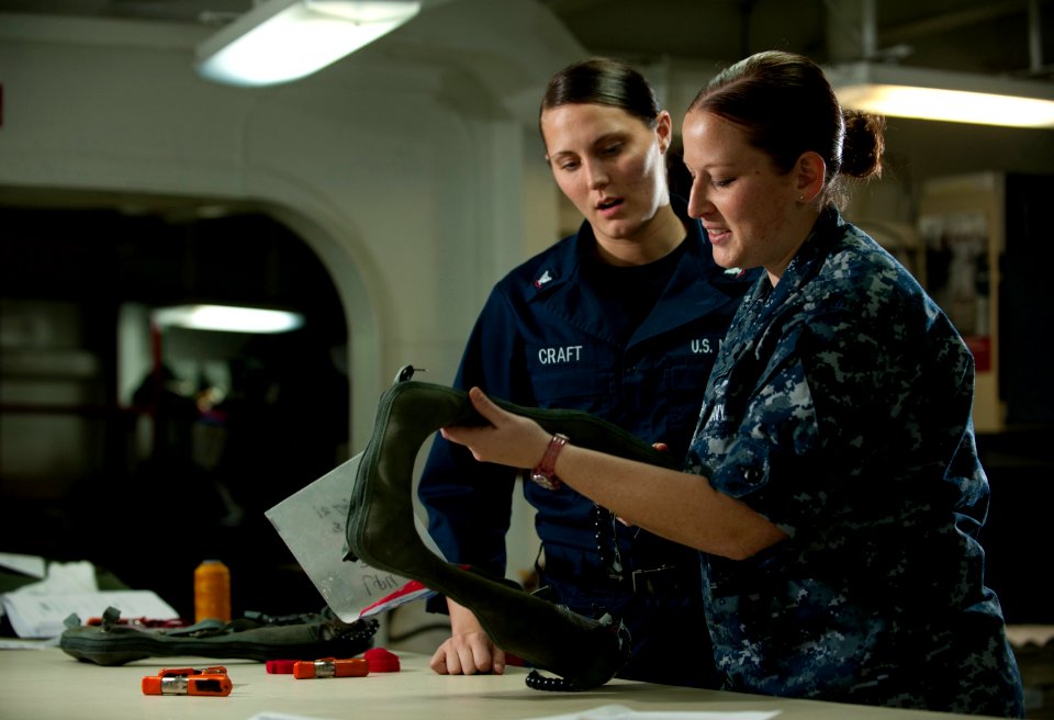 US Navy 111214-N-DR144-177 Aircrew Survival Equipmentman 2nd Class Emilie Mincher inspects LPU-34B-P low-profile floatation collars after a 360-day