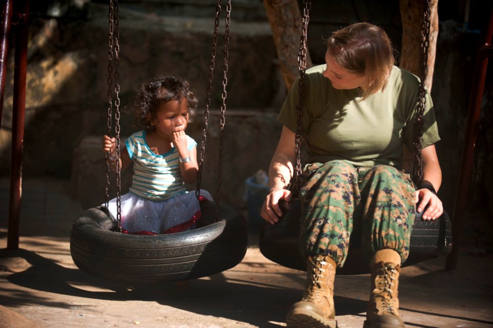 US Navy 111215-N-PB383-501 Staff Sgt. Spring Kervayas, assigned to the 11th Marine Expeditionary Unit (11th MEU), talks to a child during a communi
