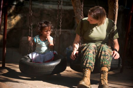US Navy 111215-N-PB383-501 Staff Sgt. Spring Kervayas, assigned to the 11th Marine Expeditionary Unit (11th MEU), talks to a child during a communi