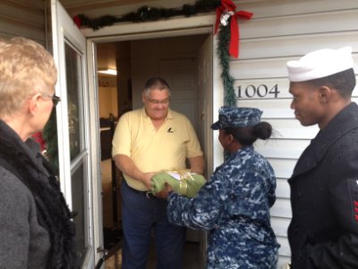 US Navy 111214-N-GO535-026 A Sailor distribute Christmas presents to homebound and elderly people