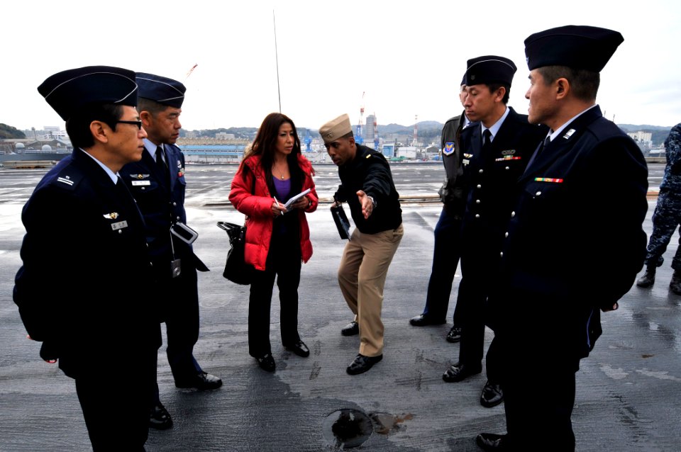 US Navy 111214-N-AW206-013 Ens. Derrick Ingle explains cyclic flight operations to officers from the Japan Air Self-Defense Force on the ship's fli