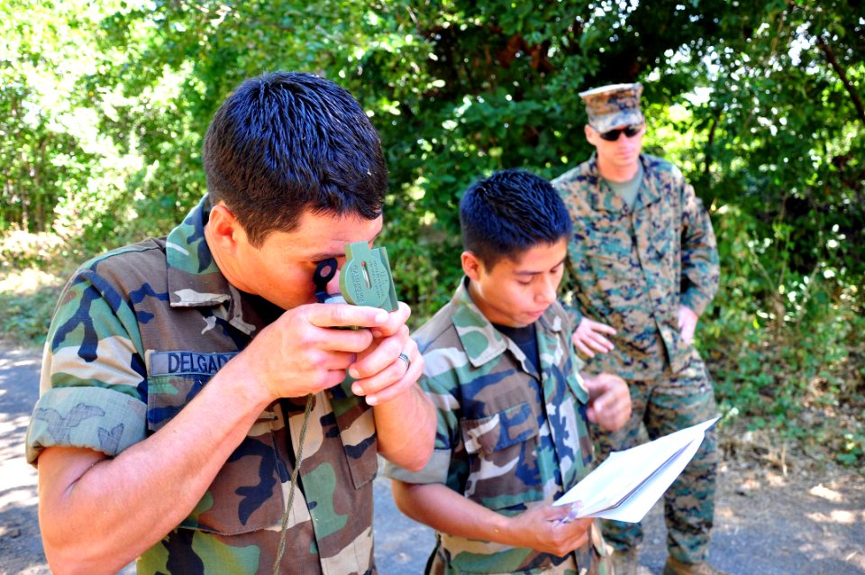 US Navy 111212-A-TF780-101 Sgt. Mark Miller observes Salvadoran Marines as they use a lensatic compass to help them complete a land navigation cour