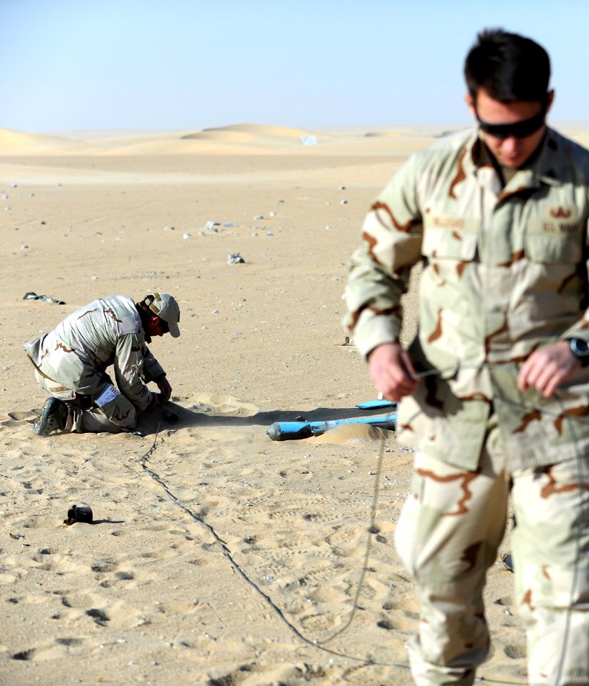 US Navy 111212-N-BA263-564 Explosive Ordnance Disposal Technician 1st Class Mike Dillon, left, and Explosive Ordnance Disposal Technician 2nd Class