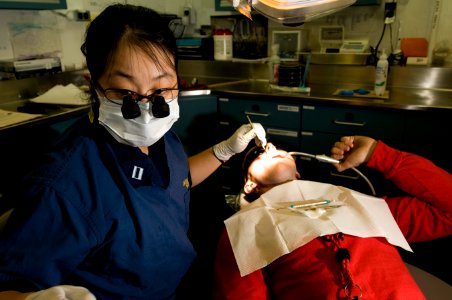 US Navy 111213-N-TZ605-137 Lt. Vicky Chang, assigned to the dental department aboard the Nimitz-class aircraft carrier USS Carl Vinson (CVN 70), cl