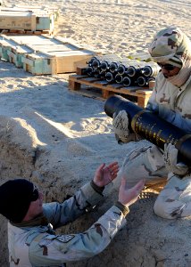 US Navy 111214-N-BA263-178 Explosive Ordnance Disposal Technician 1st Class Mike Dillon, left, assigned to Commander, Task Group (CTG) 56.1, builds