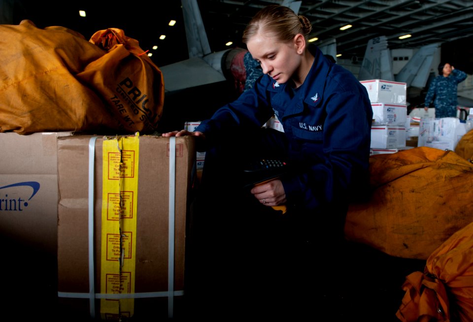 US Navy 111215-N-OY799-033 Logistics Specialist Jennifer Fasnacht sorts mail in hangar bay three aboard the Nimitz-class aircraft carrier USS John