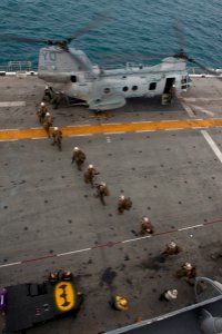 US Navy 111214-N-DX615-155 Marines embark a CH-46E Sea Stallion helicopter, assigned to the Red Dragons of Marine Medium Helicopter Squadron (HMM)