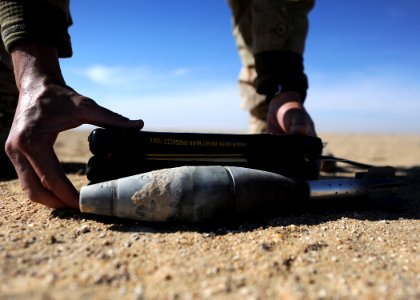 US Navy 111214-N-BA263-667 Lt. j.g. Jacob Mello, assigned to Commander, Task Group (CTG) 56.1, places a three-block composite C-4 demolition charge