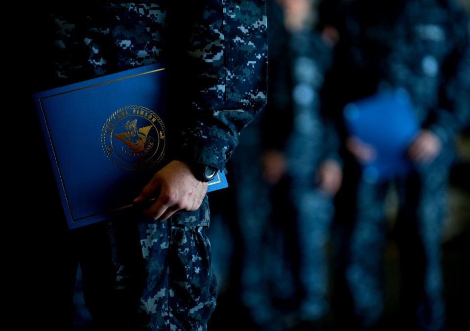 US Navy 111213-N-DR144-360 Newly promoted petty officers wait with their frocking letters to take the stage during a frocking ceremony in the hanga