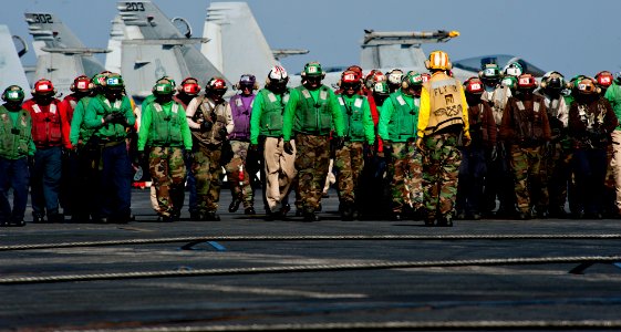 US Navy 111218-N-OY799-621 Sailors perform a foreign object damage walkdown on the flight deck of the Nimitz-class aircraft carrier USS John C. Ste