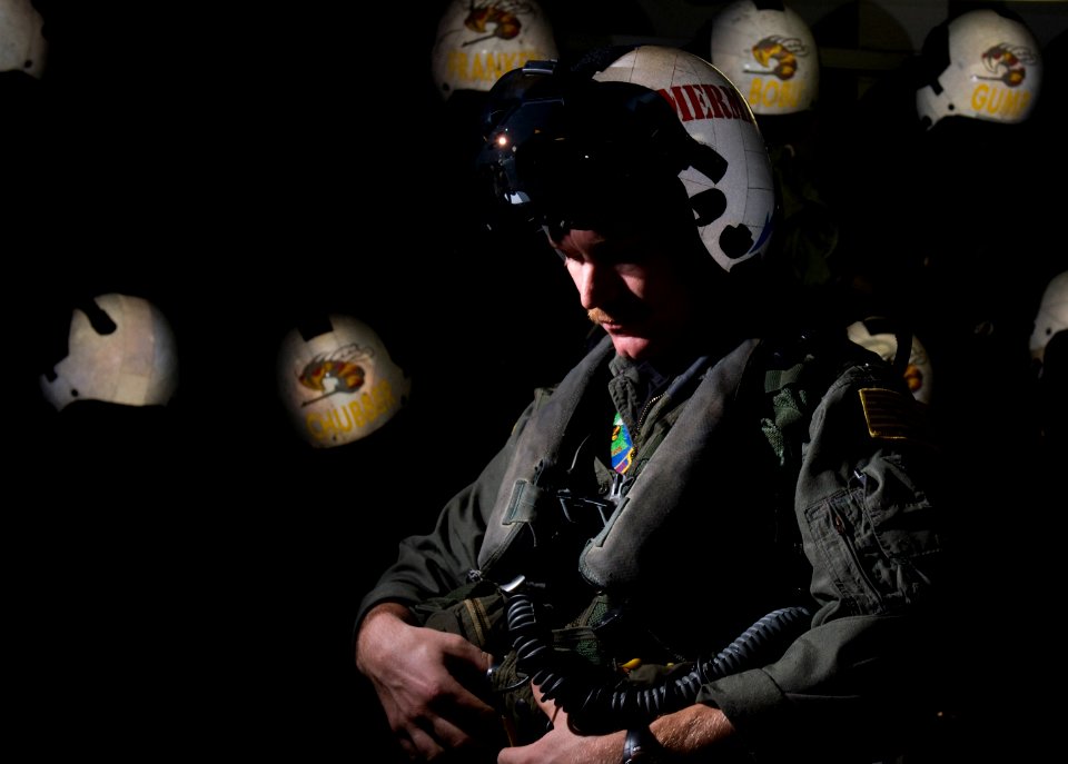 US Navy 111217-N-TZ605-051 Lt. Robert Blackwood, assigned to Strike Fighter Squadron (VFA) 113, puts on his flight suit in the squadron's paraloft