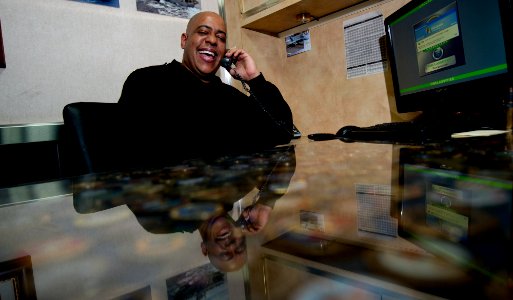 US Navy 111214-N-OY799-325 Chief Logistics Specialist Nicolas Hernandez takes a holiday telephone call from N.Y. Yankees Manager Joe Girardi