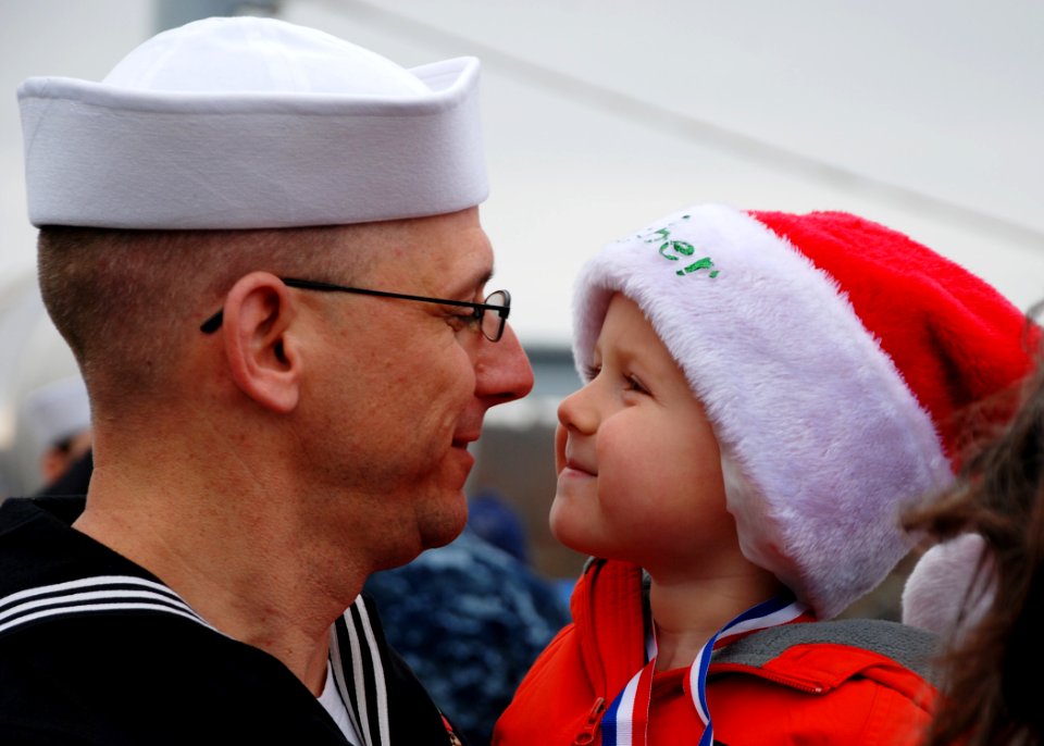 US Navy 111215-N-AW342-159 Electronics Technician 1st Class Joel Watson holds his son after returning from a five-month deployment aboard the Los A