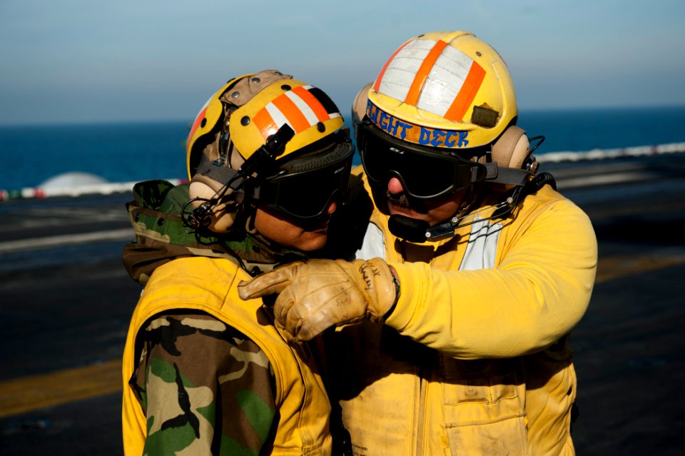 US Navy 111215-N-BT887-012 Lt. Glenn Harrison, a flight deck officer aboard the Nimitz-class aircraft carrier USS John C. Stennis (CVN 74), discuss