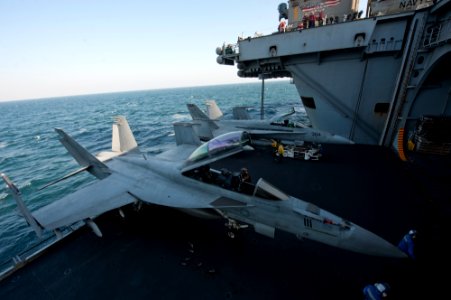 US Navy 111219-N-OY799-159 Sailors move aircraft onto an elevator aboard the Nimitz-class aircraft carrier USS John C. Stennis (CVN 74)