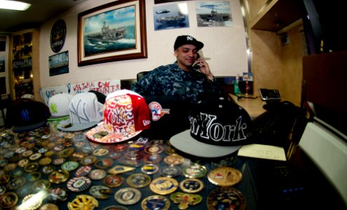 US Navy 111214-N-OY799-351 Mass Communication Specialist 3rd Class Jose Jaen takes a holiday telephone call from N.Y. Yankees Manager Joe Girardi