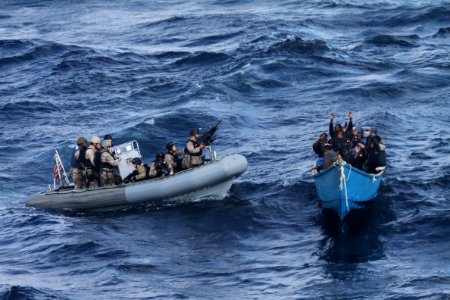 US Navy 111219-N-ZZ999-076 A visit, board, search and seizure team from the guided-missile destroyer USS Pinckney (DDG 91) approaches a suspected p photo