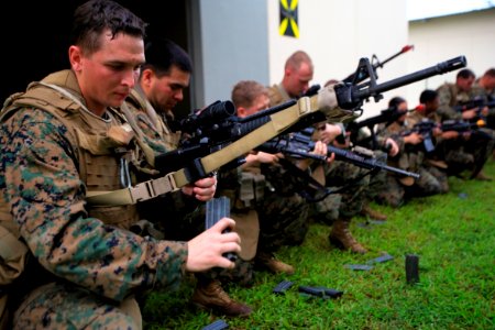 US Navy 111215-M-YP701-015 Lance Cpl. Eric W. Lunau reloads his weapon during a combat marksmanship course photo