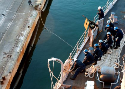 US Navy 111219-N-NR955-058 Sailors heave a mooring line during sea and anchor detail docking as the Whidbey Island-class amphibious dock landing sh