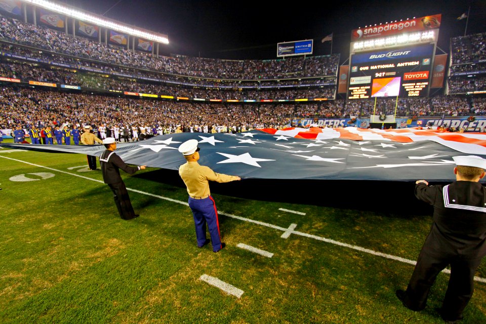 US Navy 111218-N-RC734-068 Sailors and Marines from the greater San Diego area hold an American flag during the national anthem
