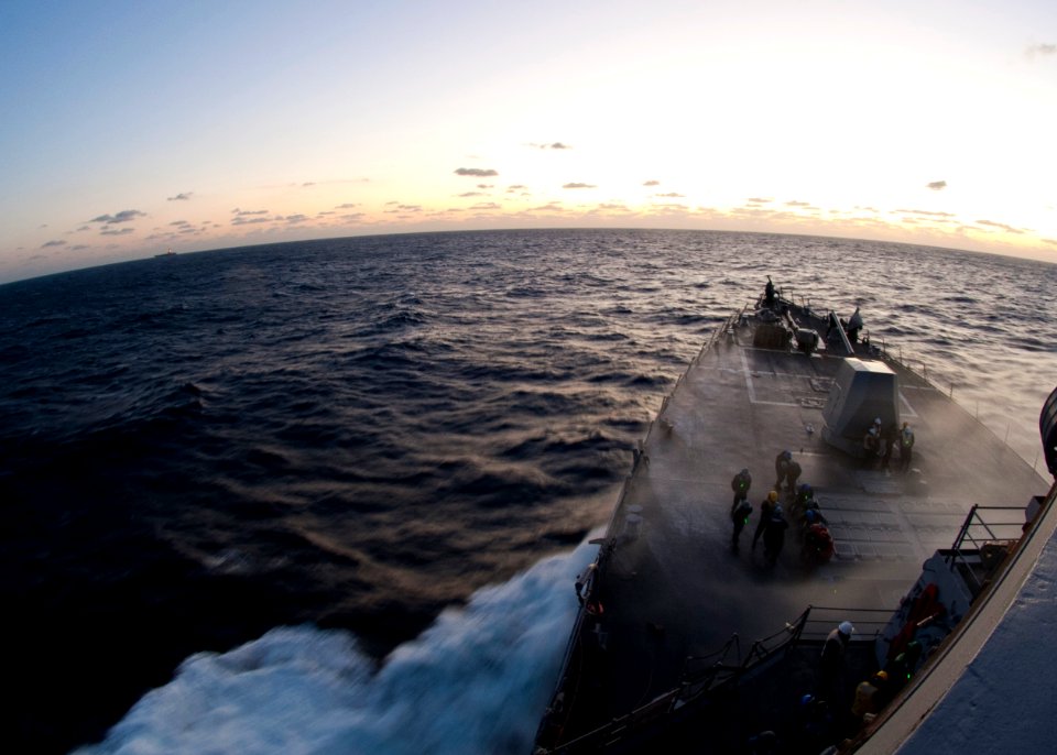 US Navy 111214-N-FI736-039 Sailors are doused with sea spray while preparing for an underway replenishment