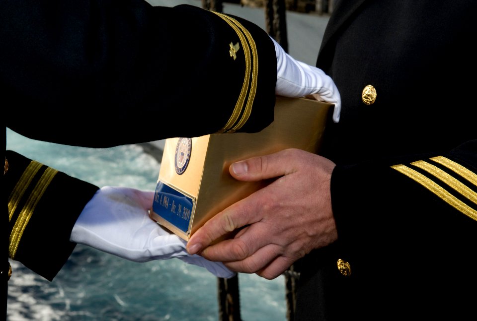 US Navy 111215-N-VO377-014 Lt. David L. Duprey takes possession of the cremated remains of former Chief Hull Technician Timothy A. Cook