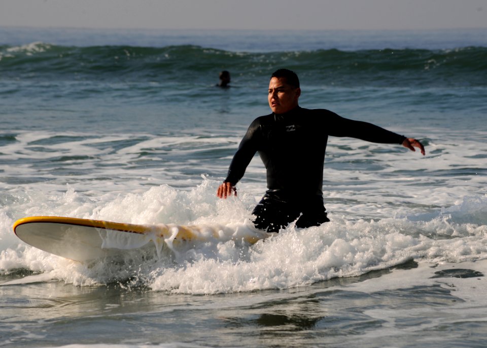 US Navy 111215-N-ZZ999-097 Lance Cpl. Eric Rodriguez, a patient at Wounded Warrior Battalion West, Naval Medical Center San Diego, learns to surf a