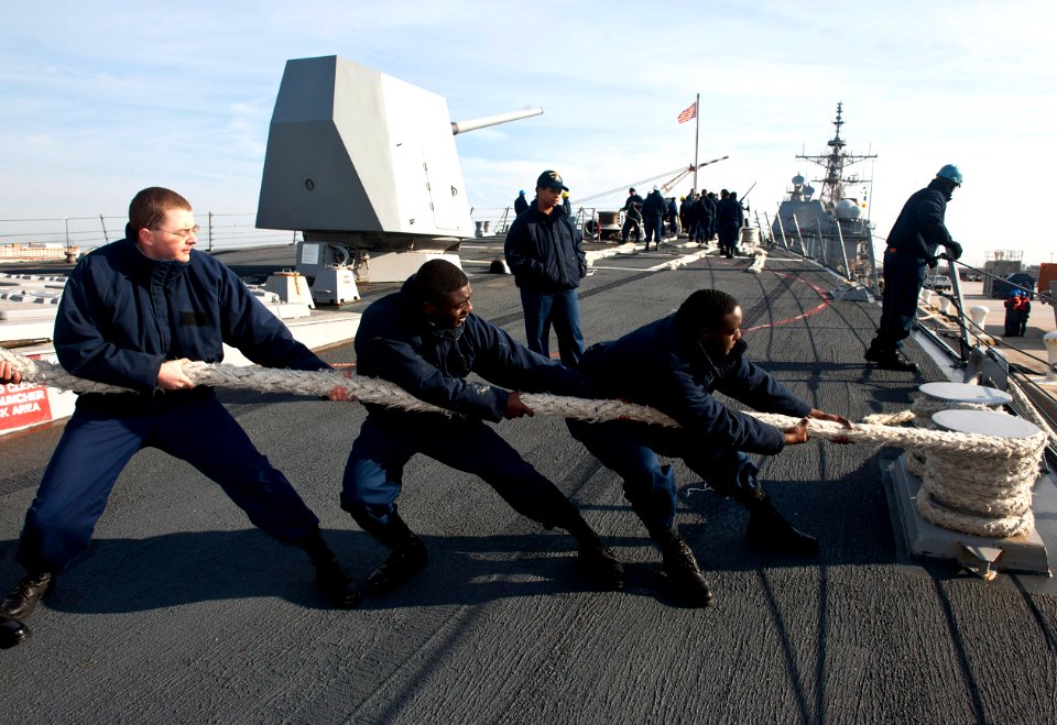 US Navy 111215-N-FI736-169 Sailors heave around a mooring line on the forecastle of Arleigh Burke-class guided-missile destroyer USS James E. Willi