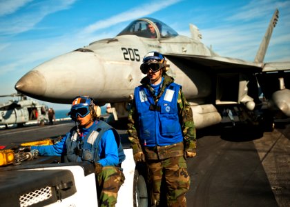 US Navy 111215-N-BT887-155 Aviation Boatswain's Mate (Handling) 3rd Class Dan Angelo Tulabot and Aviation Boatswain's Mate (Handling) Airman Justin