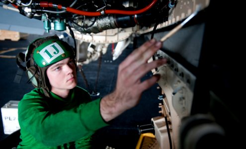 US Navy 111215-N-OY799-044 Aviation Machinist's Mate Airman Troy Harbour performs a maintenance conditional inspection on an F-A-18F Super Hornet a