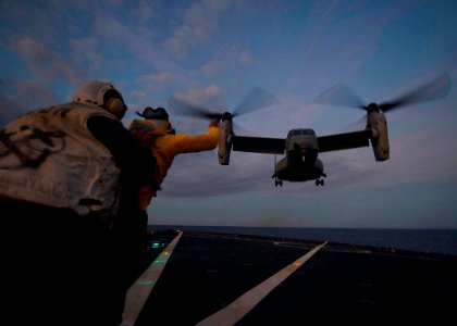 US Navy 111215-N-NR955-121 Sailors aboard the Whidbey Island-class amphibious dock-landing ship USS Gunston Hall (LSD 44) guide a MV-22 Osprey to a