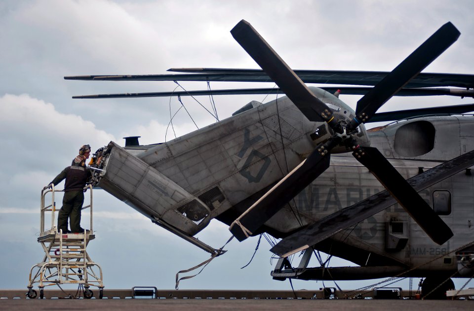 US Navy 111220-N-DX615-041 Marines perform maintenance on a CH-53E Super Stallion helicopter, assigned to the Red Dragons of Marine Medium Helicop
