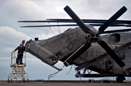 US Navy 111220-N-DX615-041 Marines perform maintenance on a CH-53E Super Stallion helicopter, assigned to the Red Dragons of Marine Medium Helicop