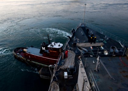 US Navy 111219-N-NR955-029 Tugboats assist the Whidbey Island-class amphibious dock landing ship USS Gunston Hall (LSD 44) photo