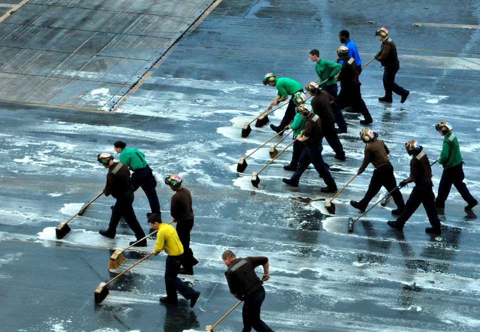 US Navy 111215-N-ZI635-083 Air department and squadron personnel scrub the flight deck aboard the Nimitz-class aircraft carrier USS Carl Vinson (CV