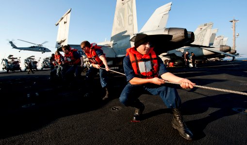 US Navy 111221-N-OY799-186 Sailors secure the phone and distance line on the flight deck during a replenishment at sea aboard the Nimitz-class airc