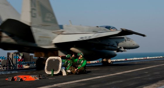 US Navy 111218-N-OY799-181 An F-A-18C Hornet from the Warhawks of Strike Fighter Squadron (VFA) 97 launches from the flight deck of the Nimitz-clas