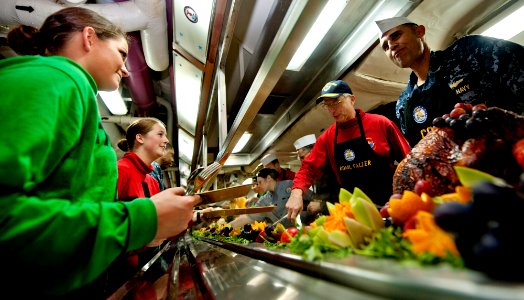 US Navy 111220-N-OY799-285 Capt. Ronald Reis and Adm. Craig Faller serve Sailors in the aft galley aboard the Nimitz-class aircraft carrier USS Joh