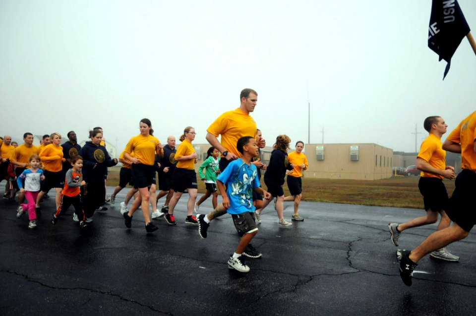 US Navy 111221-N-SN160-023 Seabees assigned to Naval Mobile Construction Battalion (NMCB) 74 and their families participate in an early morning phy
