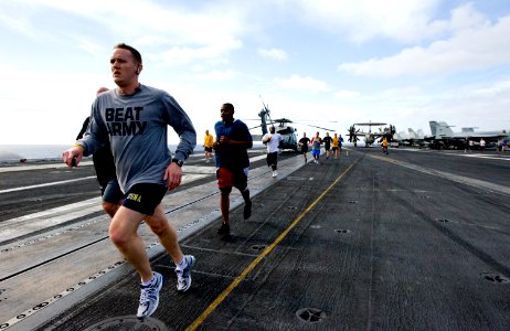 US Navy 111216-N-VO377-051 Sailors participate in a 5k Fun Run on the flight deck of the Nimitz-class aircraft carrier USS Abraham Lincoln (CVN 72)