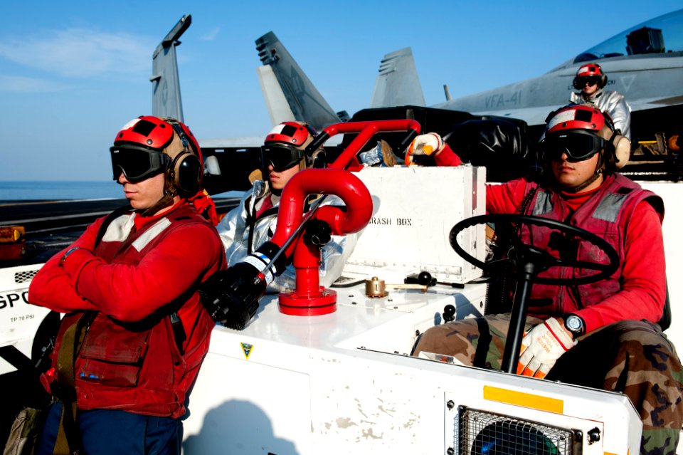 US Navy 111222-N-OY799-311 Sailors from crash and salvage observe flight operations on the flight deck of the Nimitz-class aircraft carrier USS Joh