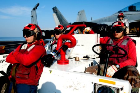 US Navy 111222-N-OY799-311 Sailors from crash and salvage observe flight operations on the flight deck of the Nimitz-class aircraft carrier USS Joh