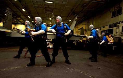 US Navy 111217-N-JN664-024 Sailors participate in an aircraft fire drill in the hangar bay of the Nimitz-class aircraft carrier USS Abraham Lincoln