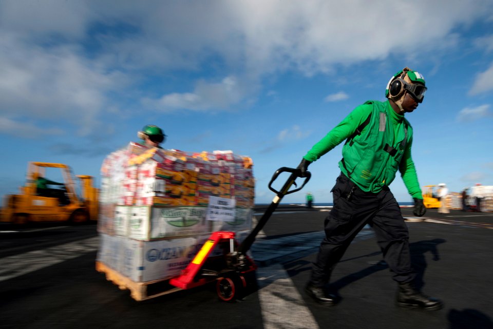 US Navy 111220-N-DR144-621 Sailors assigned to the Nimitz-class aircraft carrier USS Carl Vinson's (CVN 70) supply department move pallets of store